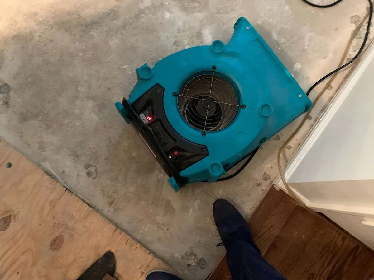Air mover drying subfloor during Commercial Water Damage Restoration in Sugar Grove
